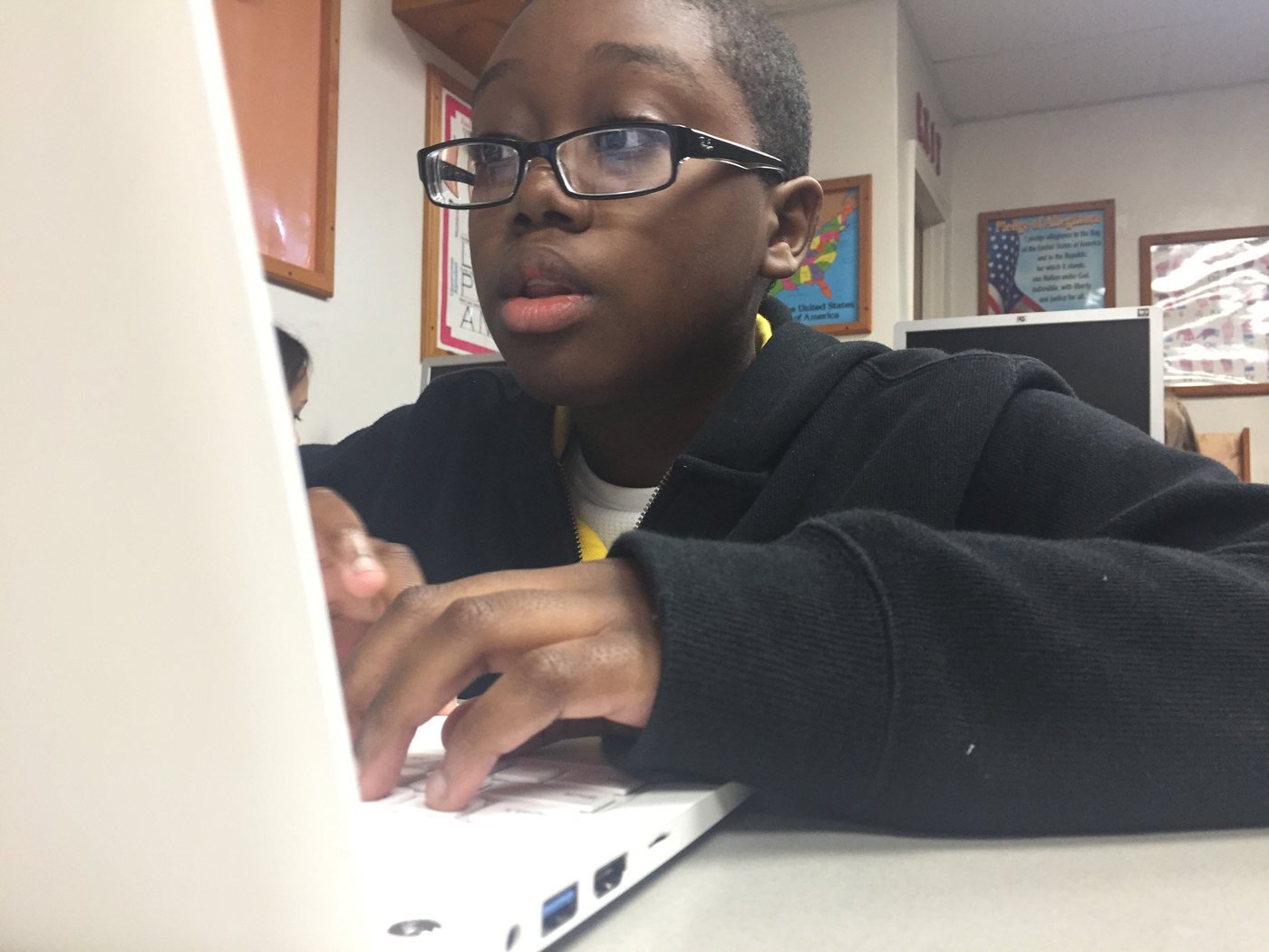 A student working on a laptop in class